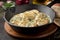 Chicken fillet or Turkey breast in creamy sauce with dill and garlic, in cast iron black pan on dark background. Delicious