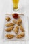 Chicken fingers with sauce and beer over white wooden background