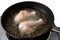 Chicken frying in a pan.