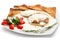 Chicken with gorgonzola, vegetables and bread on the plate