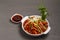 Chicken Hakka Schezwan Noodles served in a bowl with Schezwan sous . selective focus