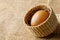 Chicken or hen egg in wicker basket on sackcloth