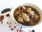 Chicken herbal soup and the herbs ingredient isolated on white background. Selective focus.