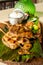 Chicken Inasal, a variant of lechon manok, on a banana leaf on top of wooden platter. It is popular grilled dish.