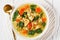 Chicken kale veggies soup in a bowl