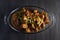 Chicken karahi in a dish on a dark background