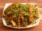 Chicken Kothu Parotta or Curried Shredded Indian flatbread a popular South Indian street food. made with layered bread pieces and