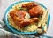 Chicken leg quarters over the millet on a plate