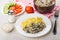 Chicken liver with pasta, salt, horseradish, slices tomato, cucumber, fork