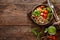 Chicken lunch bowl with broccoli, fresh tomato, pearl barley porridge and basil pesto