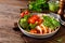 Chicken lunch bowl with broccoli, fresh tomato, pearl barley porridge and basil pesto