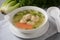 Chicken Matzo ball soup with carrots in the bowl.