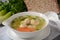 Chicken Matzo ball soup with carrots in the bowl.