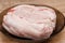 Chicken meat is defrosted in a plate in the kitchen before cooking
