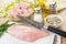 Chicken meat and knife on cutting board, spices, vegetable oil