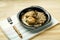 Chicken meatballs with mushrooms in a creamy sauce with green buckwheat in a plate on a linen napkin.