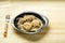 Chicken meatballs with mushrooms in a creamy sauce with a side dish of green buckwheat in a plate with a fork.