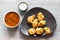 Chicken Pakoda pieces on plate on wooden table