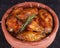 Chicken in paprika sauce baked in the oven in pottery. Chicken legs and wings