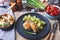 Chicken with potatoes, salted tomatoes and pickled mushrooms. In the background is a glass of vodka, a decanter, a salt shaker, on