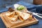 Chicken Quesadillas on Wooden Cutting Board on blue background