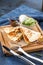 Chicken Quesadillas on Wooden Cutting Board on blue background