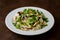 Chicken and rice with Valeriana salad on a plate on a wooden table