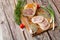 Chicken roll in grid decorated lettuce leaf isolated on wooden background. Fresh meat product whole and partly sliced