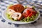 Chicken schnitzel cordon bleu and salad on a plate close-up. horizontal