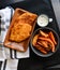 Chicken schnitzel with garlic mayo and sweet potato chips and spicy wedges