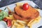 Chicken schnitzel served with potato chips