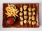 Chicken skewers. Pieces of tender chicken fillet, grilled with sweet onion rings, and garnished with french fries and