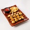 Chicken skewers. Pieces of tender chicken fillet, grilled with sweet onion rings, and garnished with french fries