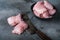 Chicken skinless thighs on grey background