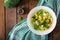 Chicken soup with broccoli, green peas, carrots and celery