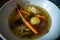 Chicken soup with meat carrot onion leek parsley and noodles plate