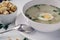 Chicken soup in a white plate with bowl pieces