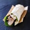 Chicken spinach mushroom wrap on slate