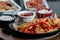 Chicken steak fajita with sauces on table stock photo