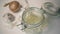 Chicken stock is poured into a glass jar. Slow mo