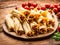 Chicken tamales wrapped in corn husks in a stack on a cutting board
