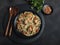 Chicken teriyaki with asian noodles udon , sesame, rustic stone background. Closeup. Chinese/Japanese noodles