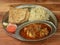 Chicken Thali from an indian cuisine, food platter consists of Chicken curry, jeera rice, roti and onions., selective focus