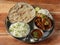 Chicken Thali from an indian cuisine, food platter consists variety of veggies,Chicken meat, lentils,rice, sweet dish, snacks etc