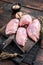 Chicken thigh fillet, Raw Boneless and skinless meat on a cutting board. Wooden background. Top view