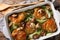 Chicken thighs with baby bok choy, shiitake mushrooms and cheese sauce in a rustic style close-up. horizontal top view from above