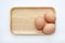 Chicken three eggs on wooden tray isolated on white background