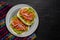 Chicken tinga tacos with guacamole and onion on dark background. Mexican food