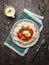 Chicken tomato stew with basmati rice with yoghurt sauce in plate and fork on wooden background