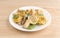 Chicken and tortellini TV dinner on a white plate